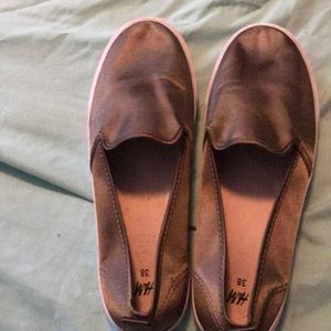 A pair of dark shiny tan slip ones